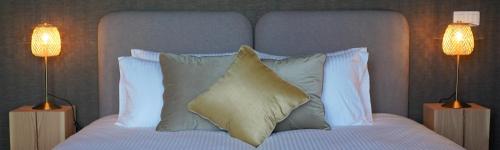 a bedroom with a bed with a pillow and two lamps at Les Terrasses des Falizes B&B in Rochefort
