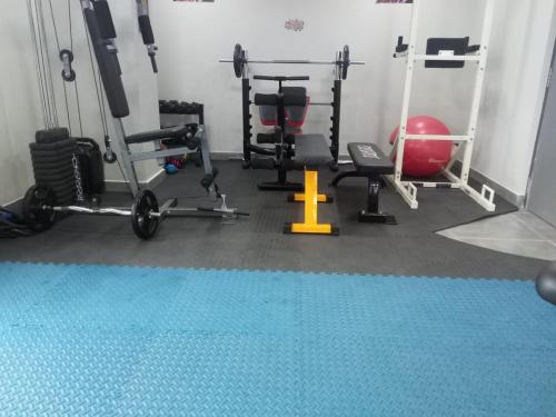 a gym with several tread machines and a ball at The Soni'otel in Hāora