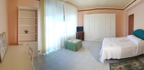 a bedroom with a bed and a large window at Stylish Apt TERINA - Le Lincelle, Lamezia - bright, spacious, elegant and with terrace in SantʼEufemia Lamezia