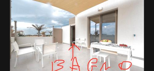 a white dining room with a table and chairs at Arabel open space in San Lorenzo