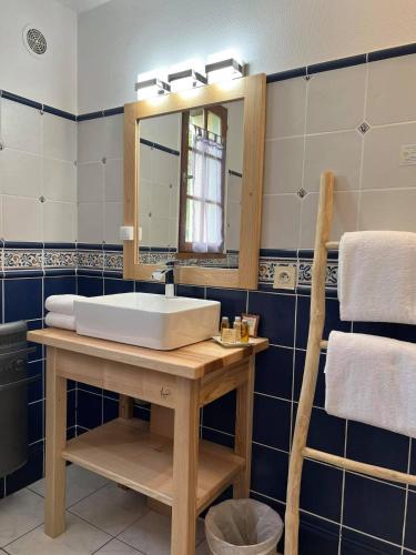 a bathroom with a sink and a mirror at Hôtel Les Vieilles Tours Rocamadour in Rocamadour