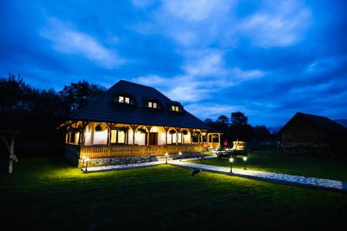 a large building with lights on it at night at Casa Moroșanului Vișeu de Sus in Vişeu de Sus