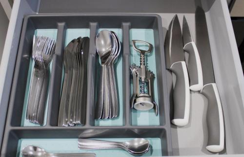 a drawer filled with utensils and silverware at Didcot- Private Flat with Garden & Parking 03 in Didcot