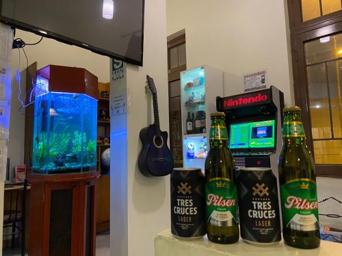 a room with two bottles of beer and a video game at Lima House Hostel in Lima