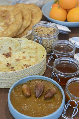 a table topped with bowls of food with bread and dips at Dar El Kif - La Marsa in La Marsa