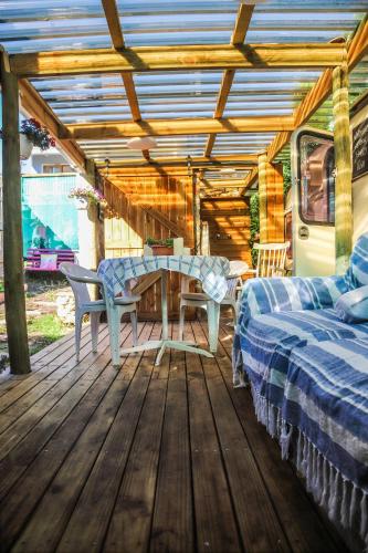 a wooden deck with two beds and a table at Happy Van in Scarborough