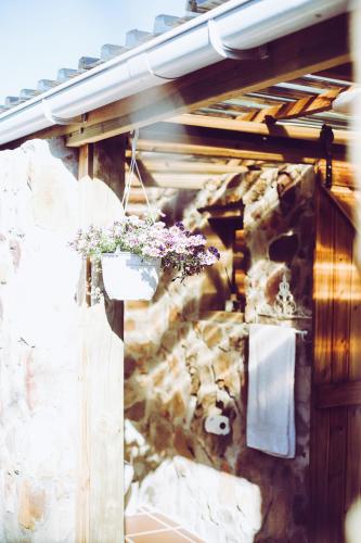 a building with flowers hanging from a wall at Happy Van in Scarborough
