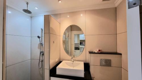 a bathroom with a sink and a mirror at View Talay 6 Pattaya Beach by CANDO in Pattaya Central