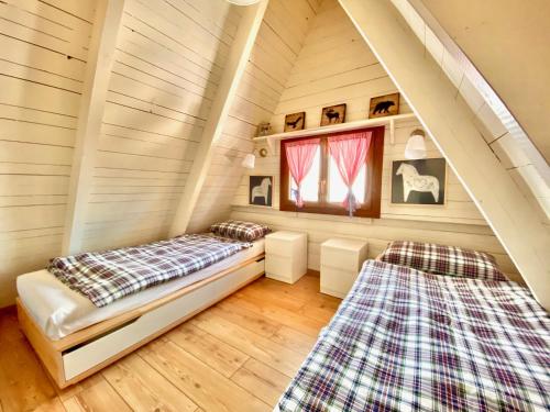 a room with two beds in a attic at Chalet Paoletta - Alpe Cermis in Cavalese