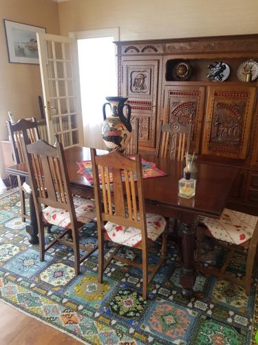 a dining room with a wooden table and chairs at Annick in Hôpital-Camfrout