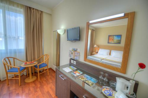 a hotel room with a bed and a mirror at The Preluna Hotel in Sliema