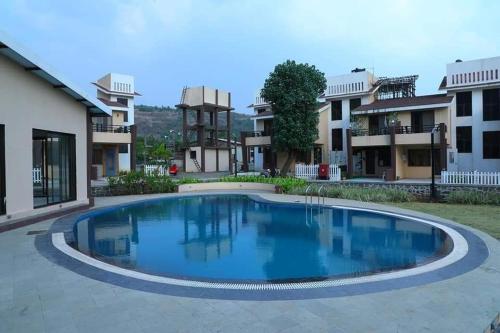 a large swimming pool in the middle of a building at Akshaya Villa in Lonavala