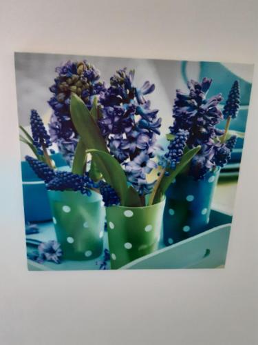 three green vases with purple flowers in them at (La parenthese) in Hombourg