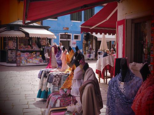 a group of people standing in front of a market at Venice Luxury Watersdoor in Venice