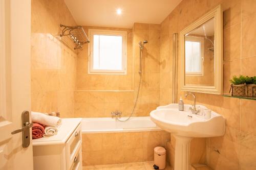 a bathroom with a sink and a shower and a tub at LE FOCH AP4244 By Riviera Holiday Homes in Nice