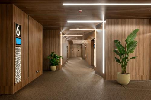 a hallway with two plants in a building at ME Barcelona in Barcelona