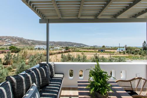a patio with chairs and a view of the desert at Arsenis Luxury Villas in Plaka