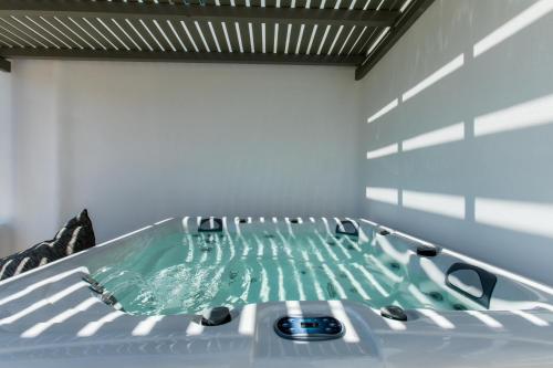 a jacuzzi tub in the middle of a room at Arsenis Luxury Villas in Plaka