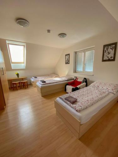 a room with three beds and a table at Chalupa - Sklep Starovice in Starovice