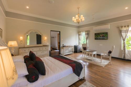 a bedroom with a bed and a table and a desk at TULI VEER BAGH RESORT TURIA in Khawāsa