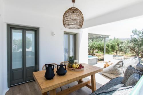 a living room with a table with a bowl of fruit at Arsenis Luxury Villas in Plaka