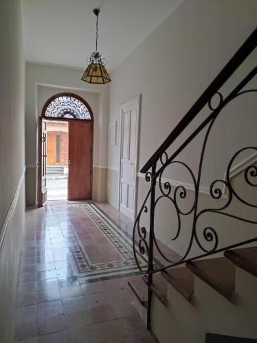 an empty hallway with a staircase and a door at Porta d'Alpi in Latronico