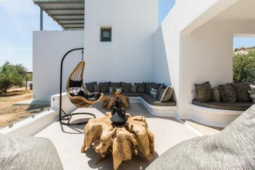 a living room with a couch and a table at Arsenis Luxury Villas in Plaka