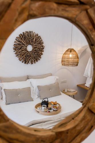a bedroom with a bed with a tray of food on it at Arsenis Luxury Villas in Plaka