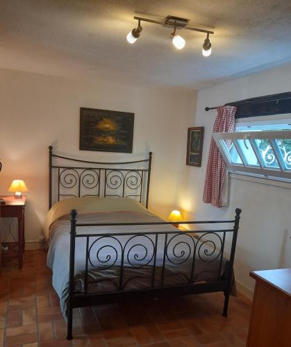 a bedroom with a bed and a window at La Grange in Rânes