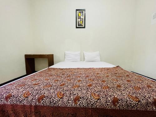 a large bed in a room with at Langko 48 RedPartner in Tanjungkarang