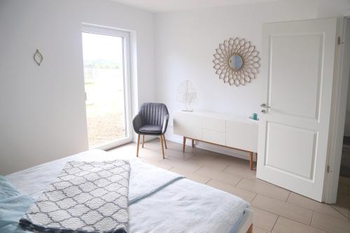 a bedroom with a bed and a desk and a chair at Auszeit mit Weitblick in der Sächsischen Schweiz - kleiner Bauernhof mit Tieren und Wallbox in Rathmannsdorf