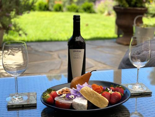 a plate of food on a table with a bottle of wine at Adagio In Auburn in Auburn