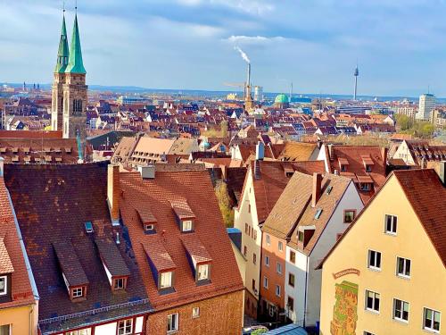a view of a city with buildings and a church at Burghotel Nürnberg in Nürnberg