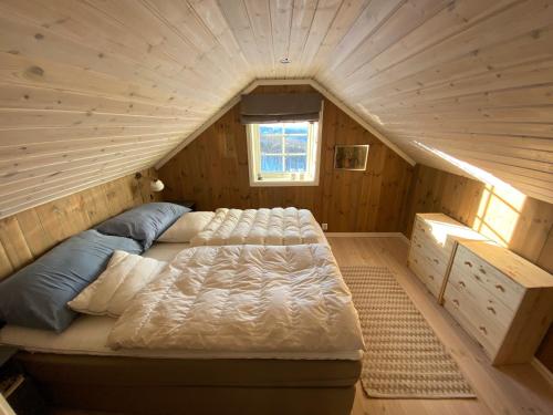 a bedroom with a bed in a wooden room at Endely - ski inn / ut in Rauland