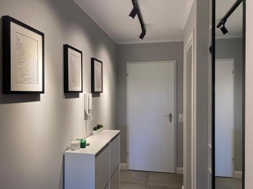 a bathroom with a white sink and a white cabinet at Schwarzwald Wohnung Kniebis in Freudenstadt