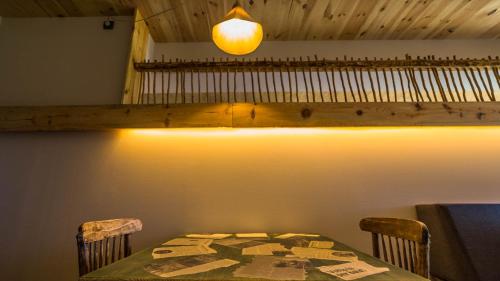 a table and chairs in a room with a light at Eco-Apartaments Cal Rossa de Taús in Taús