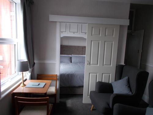a room with a bedroom with a bed and a door at Kelso House holiday flats in Blackpool