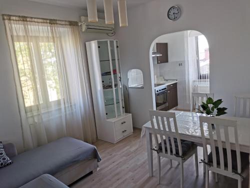 a living room with a table and a mirror at House Katarina in Ankaran