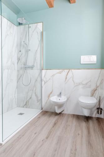 a bathroom with a shower and a toilet and a sink at Boutique Hotel Municipio 1815 in Valdobbiadene