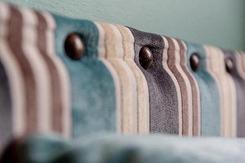 a close up of the back of a bench with brown dots at Boutique Hotel Municipio 1815 in Valdobbiadene