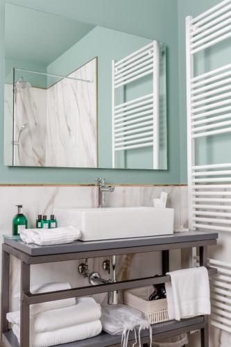 a bathroom with a sink and a mirror at Boutique Hotel Municipio 1815 in Valdobbiadene