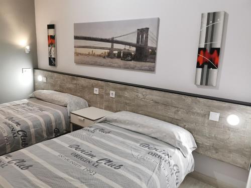 a bedroom with two beds and a bridge at Villa "Luna de Segovia" in Leganés