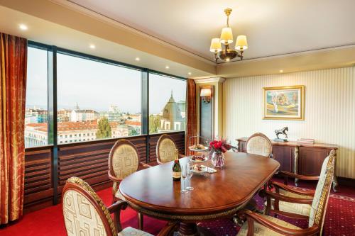 
a dining room table and chairs in a hotel room at Grand Hotel Sofia in Sofia
