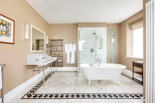 a bathroom with a tub and a shower and a sink at Ellenborough Park in Cheltenham