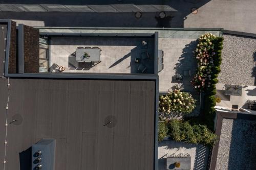an overhead view of a building with a door and plants at Sunny Ferienwohnungen Ski In - Ski Out - Self Check-in in Zell am See