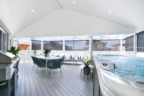 a house with a swimming pool and a table and chairs at Entire Residential Home - Lake Illawarra And Beachside Home Sleeps 12 in Lake Illawarra