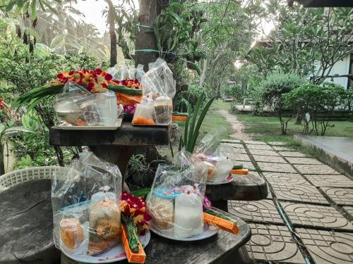 a bunch of food in plastic bags on a table at Baan Klong Resort in Damnoen Saduak