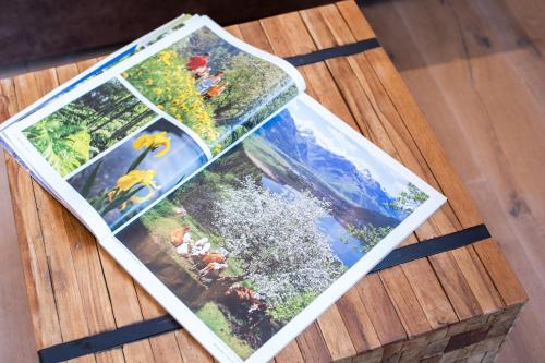 a table with three pictures on top of it at Sunny Ferienwohnungen Ski In - Ski Out - Self Check-in in Zell am See