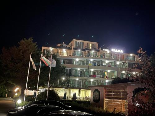 a large building with lights on it at night at Hotel Pacific Palma in Sunny Beach