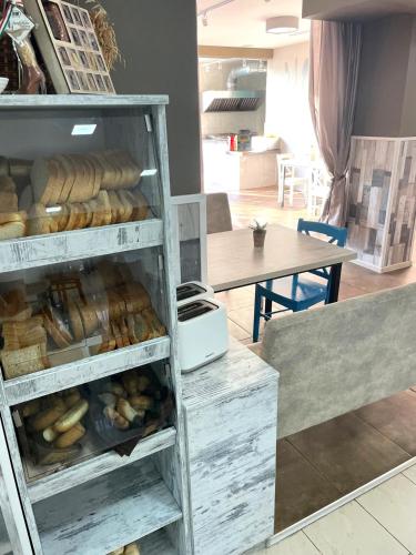 a bakery with a shelf full of loaves of bread at Hotel Pacific Palma in Sunny Beach